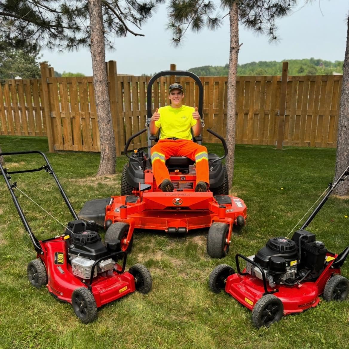 Aiden on a riding mower with Picture Perfect lawn-care equipment