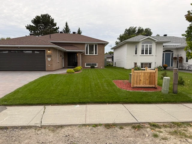 Front lawn beside a brick home and a screened utility enclosure — after, pair 33 of 36