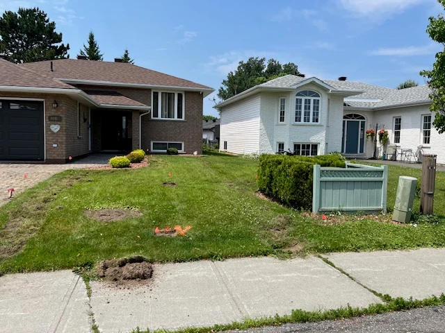 Front lawn beside a brick home and a screened utility enclosure — before, pair 33 of 36