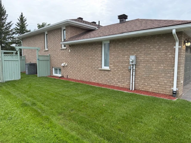 Side yard along a brick house and foundation border — after, pair 34 of 36