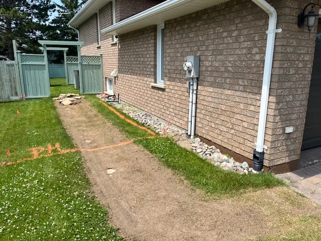 Side yard along a brick house and foundation border — before, pair 34 of 36