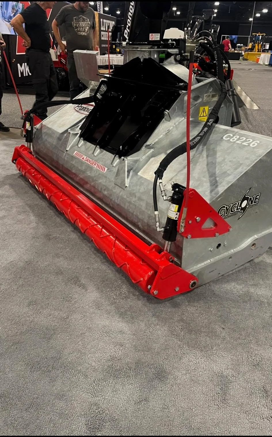 Pronovost Cyclone snowblower with a red gravel packer roller at an indoor equipment display